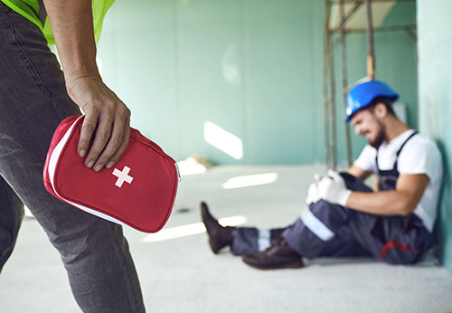 Injured worker and first aid kit on a construction site; breaking down Georgia premises liability.